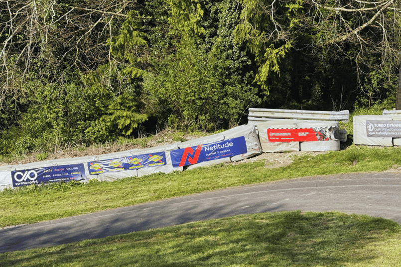 Netitude Business IT Services banner on the trackside barriers at Gurston Down Hillclimb, Wiltshire.