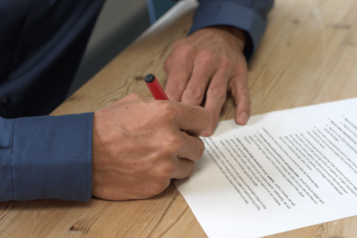 Close-up of Adam Harling signing Netitude's Cyber Resilience Pledge declaration