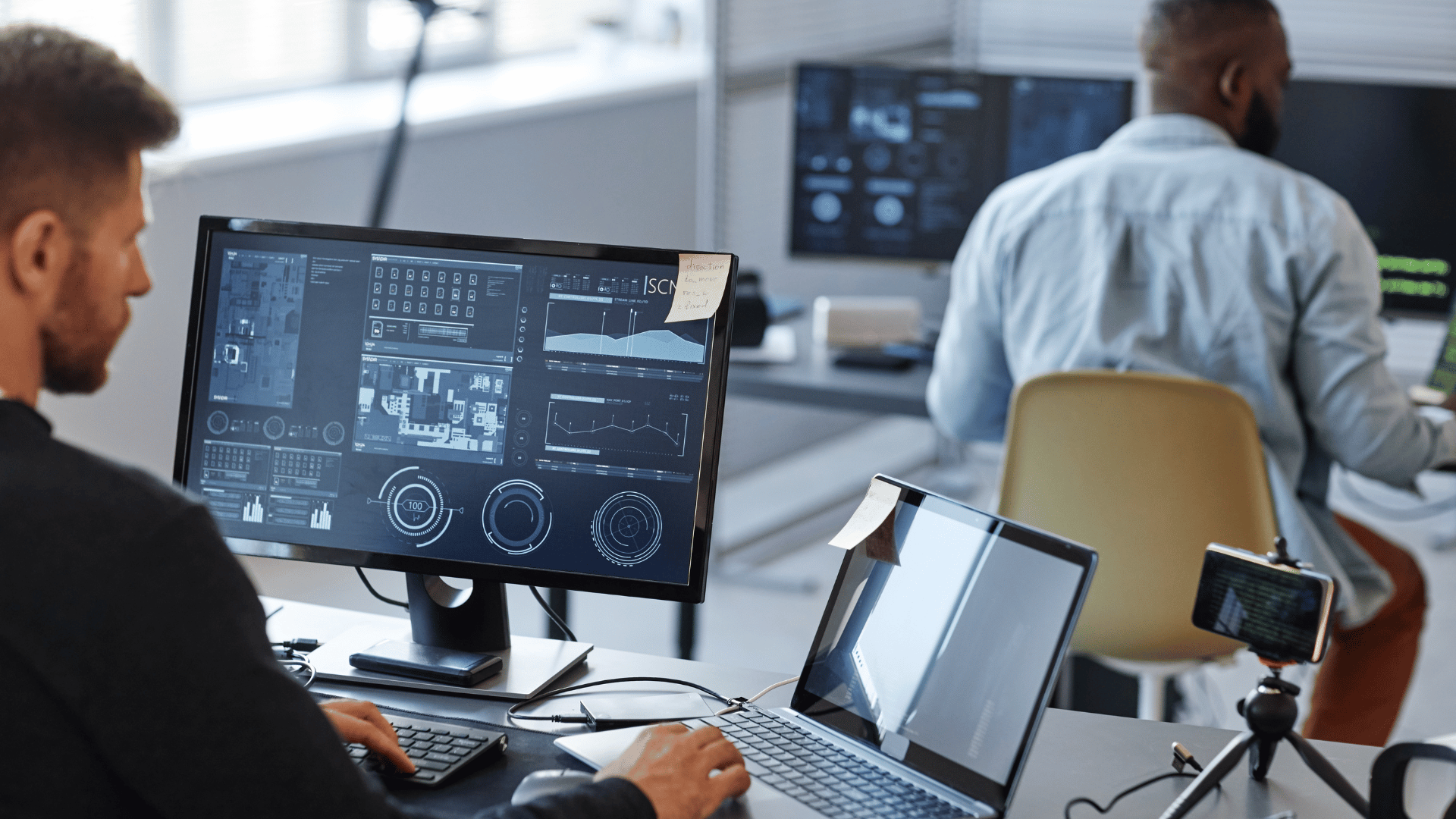 Two managed IT support workers in an office handling business continuity issues.