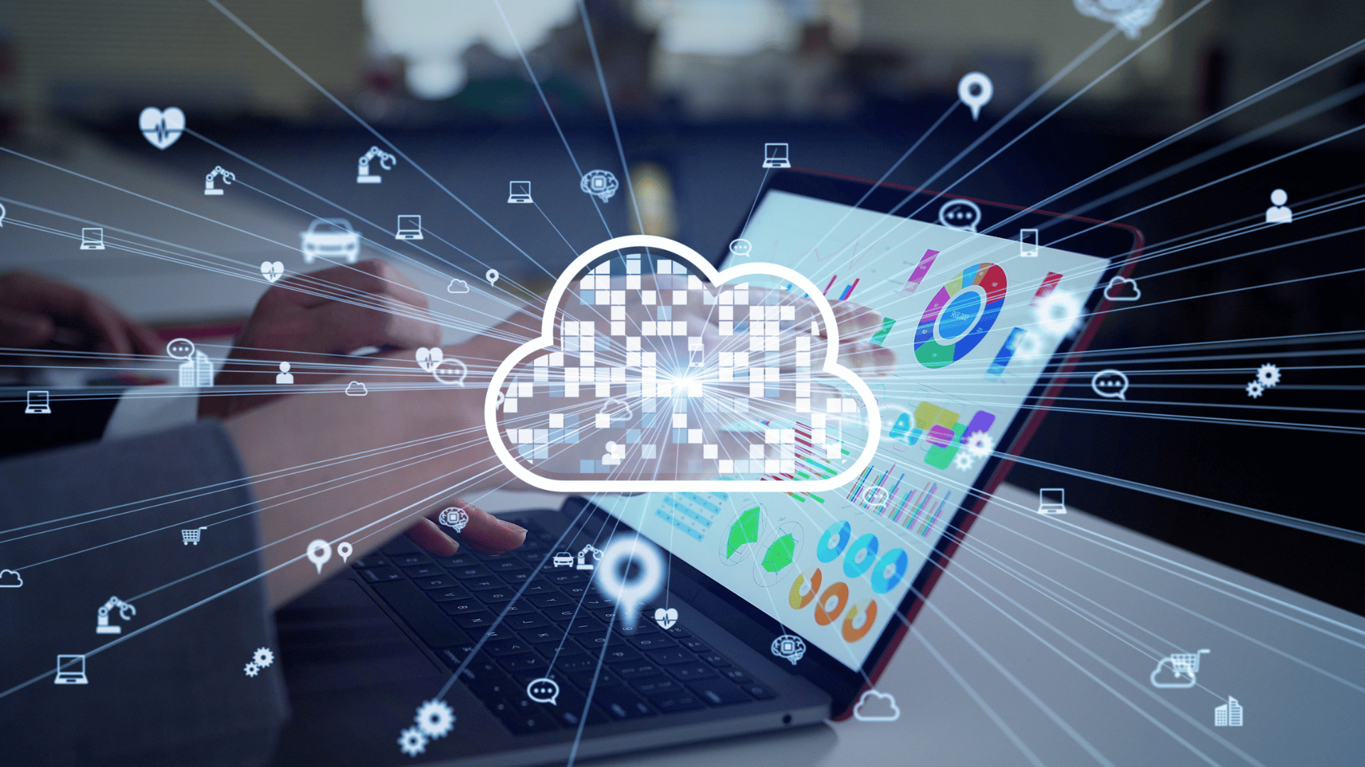 Cloud computing concept with a digital cloud icon over a laptop showing business analytics and data dashboards.