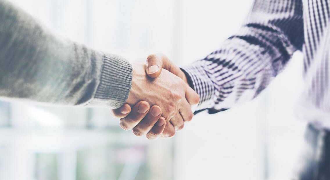 Two people shaking hands.