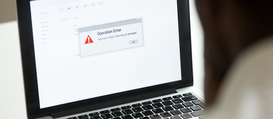 Computer error failure concept, man using laptop with application failure message on screen, bad software pc app crash, email malware, data loss and recovery, rear view over the shoulder