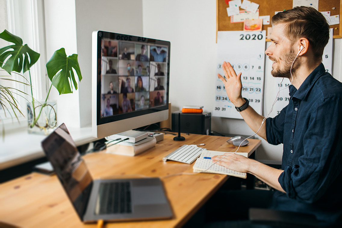 Staff memeber on a Microsoft Teams call with colleagues while at his desk