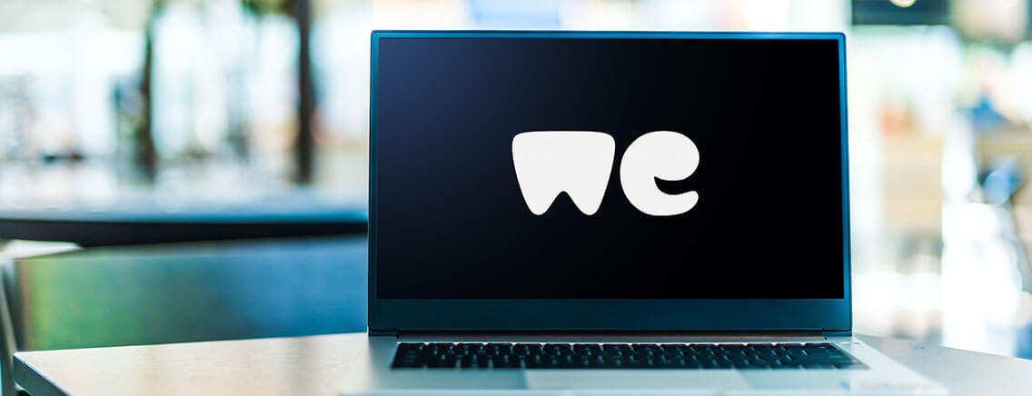 Laptop screen displaying the 'We' of the WeTransfer logo.