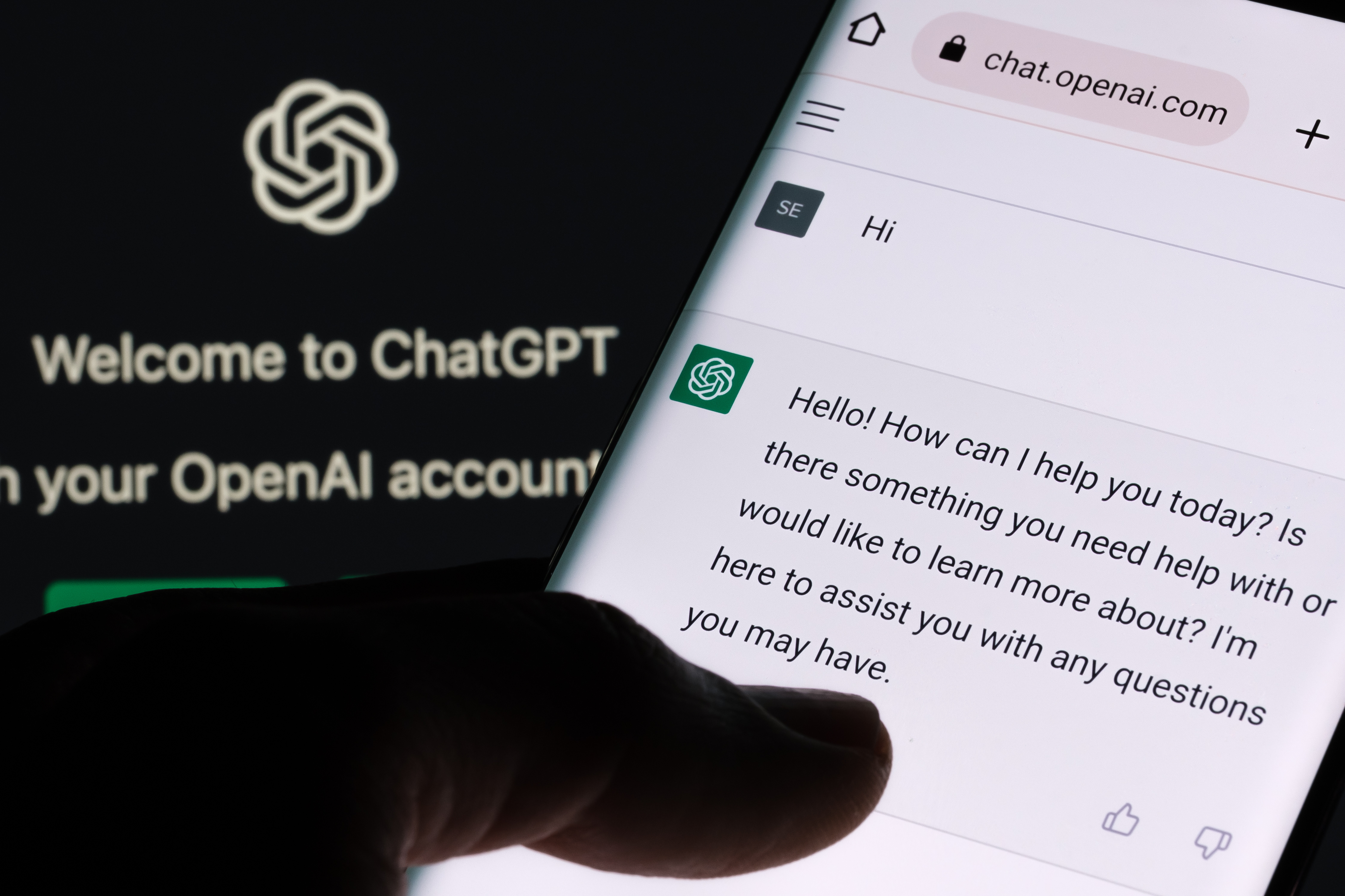 Background shows ChatGPT navigation menu; foreground shows Chat GPT response and human finger interacting with it.