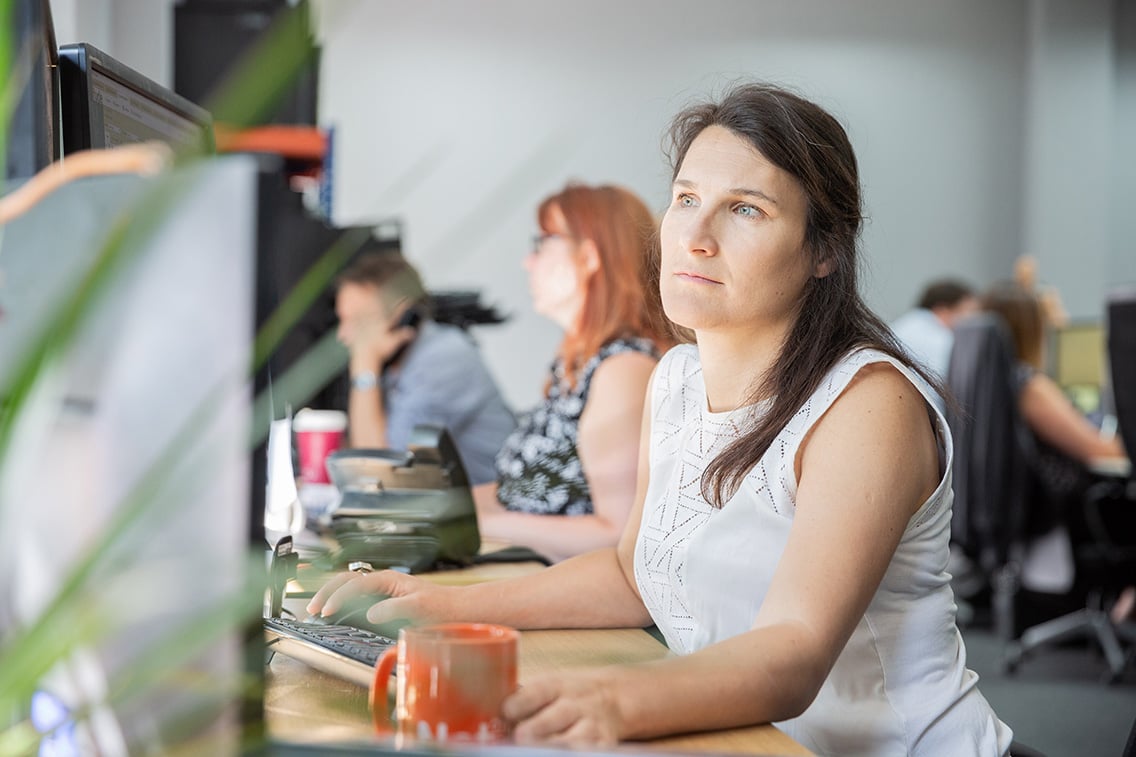 Solutions Coordinator working at her computer