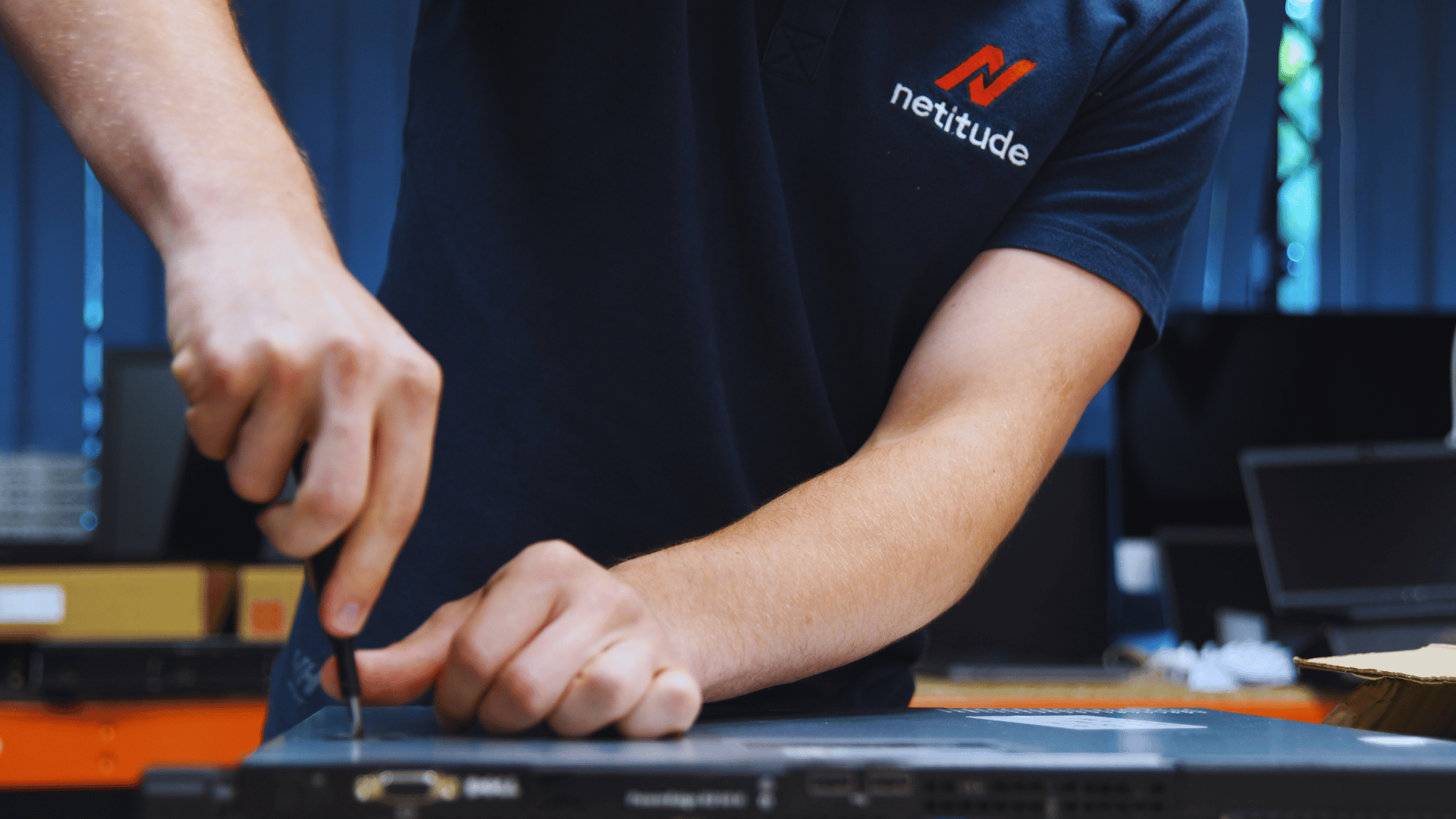 Netitude engineer working on server hardware, representing the modern infrastructure that makes businesses AI-ready