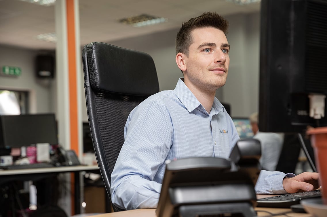 Technical Alignment Manager, working at his computer