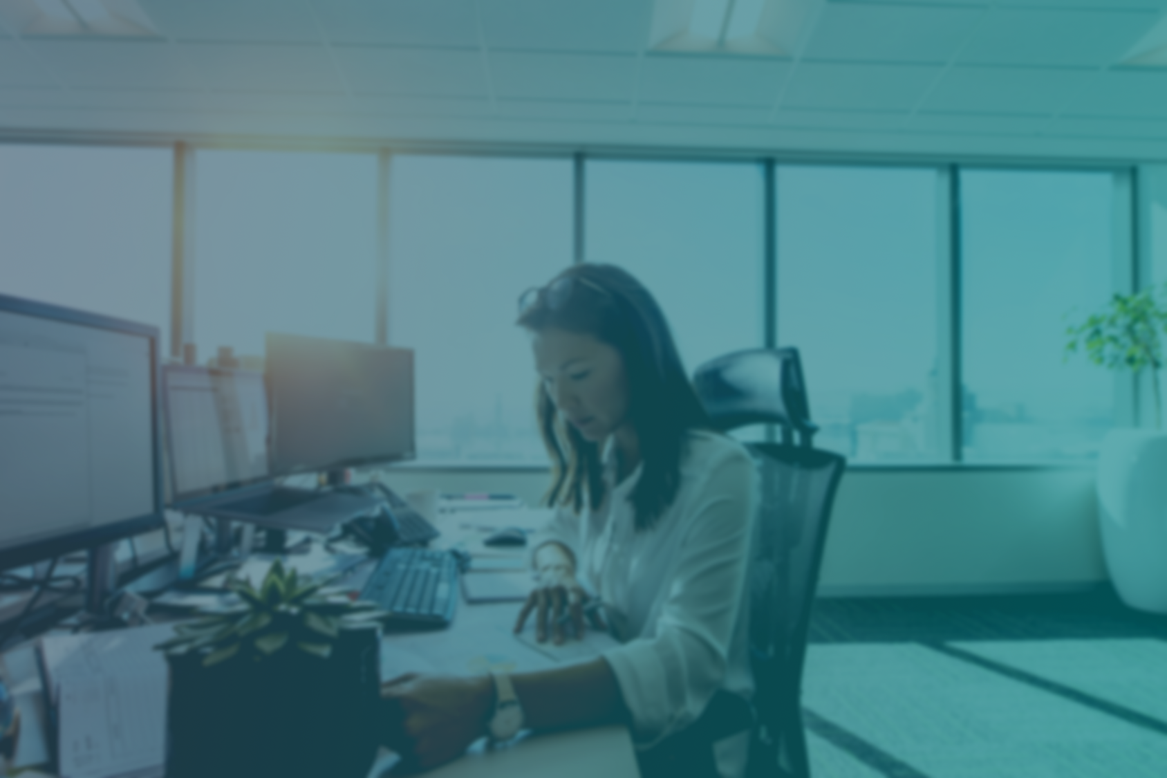 Businesswoman studying business papers on her desk. Woman working in office sitting at her desk.