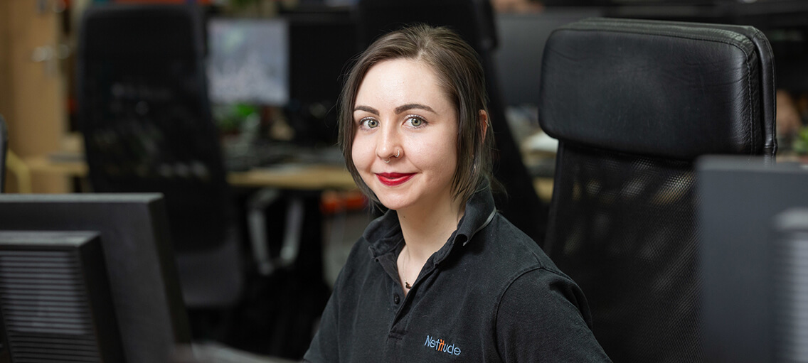 Customer Service Manager, Elena Henderson, working at her computer