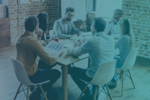 Everyday meeting. Group of six young people discuss something and gesturing while sitting at the table in office