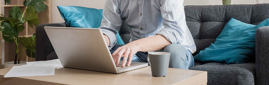 Male businessman working on laptop from home