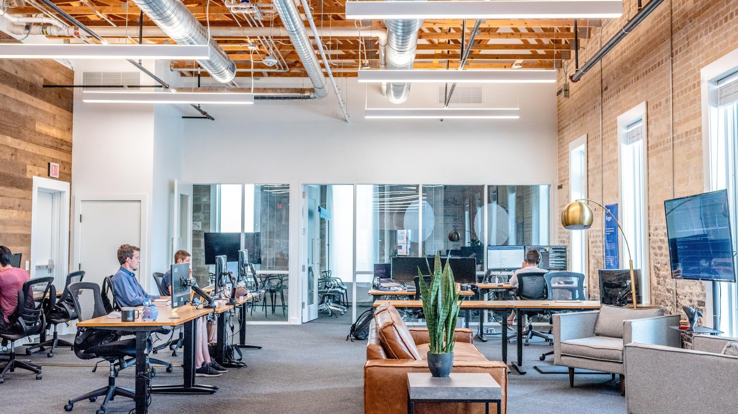 An open-plan office with staff working at their desks