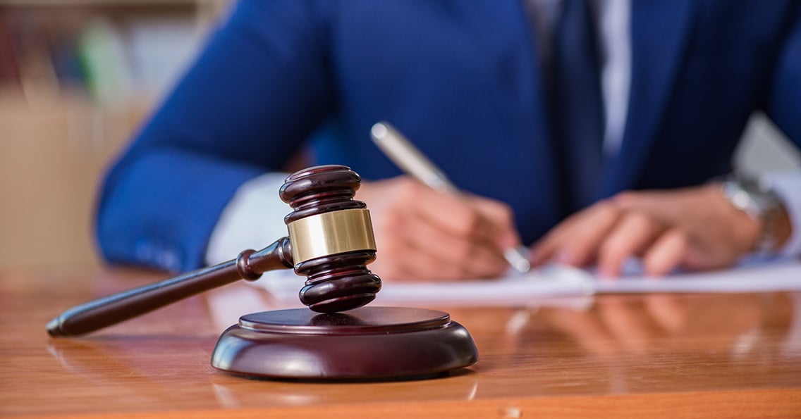 Judge with gavel sitting in courtroom