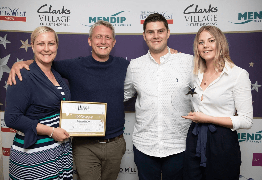 Netitude Founder and Managing Director, Adam Harling, with long standing team member, Josh Bradley accepting the business award.