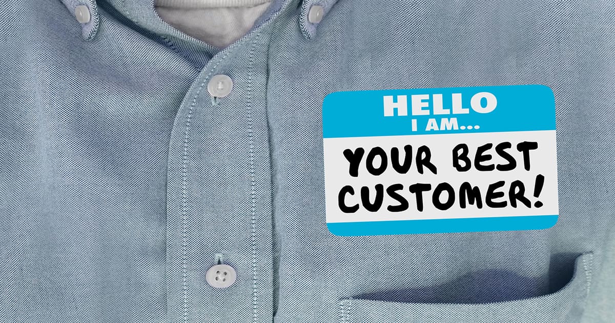 Zoomed in picture of someone wearing a shirt, cropped at the pocket, with a badge saying