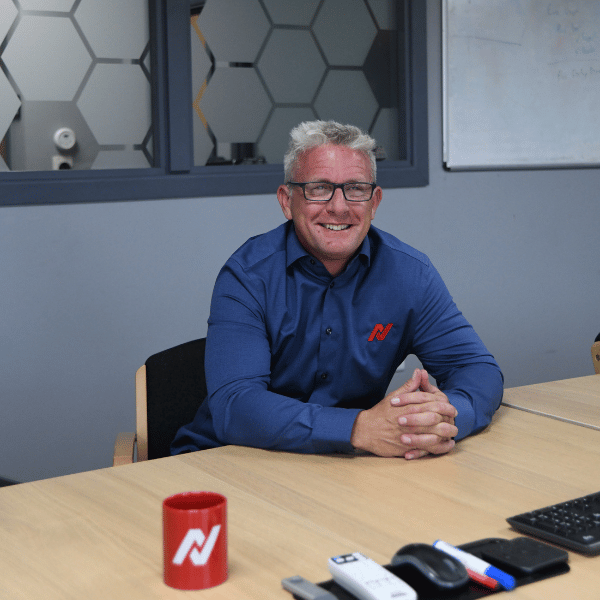 Photo of Adam Harling, Netitude Managing Director, posing with a branded Netitude mug. 