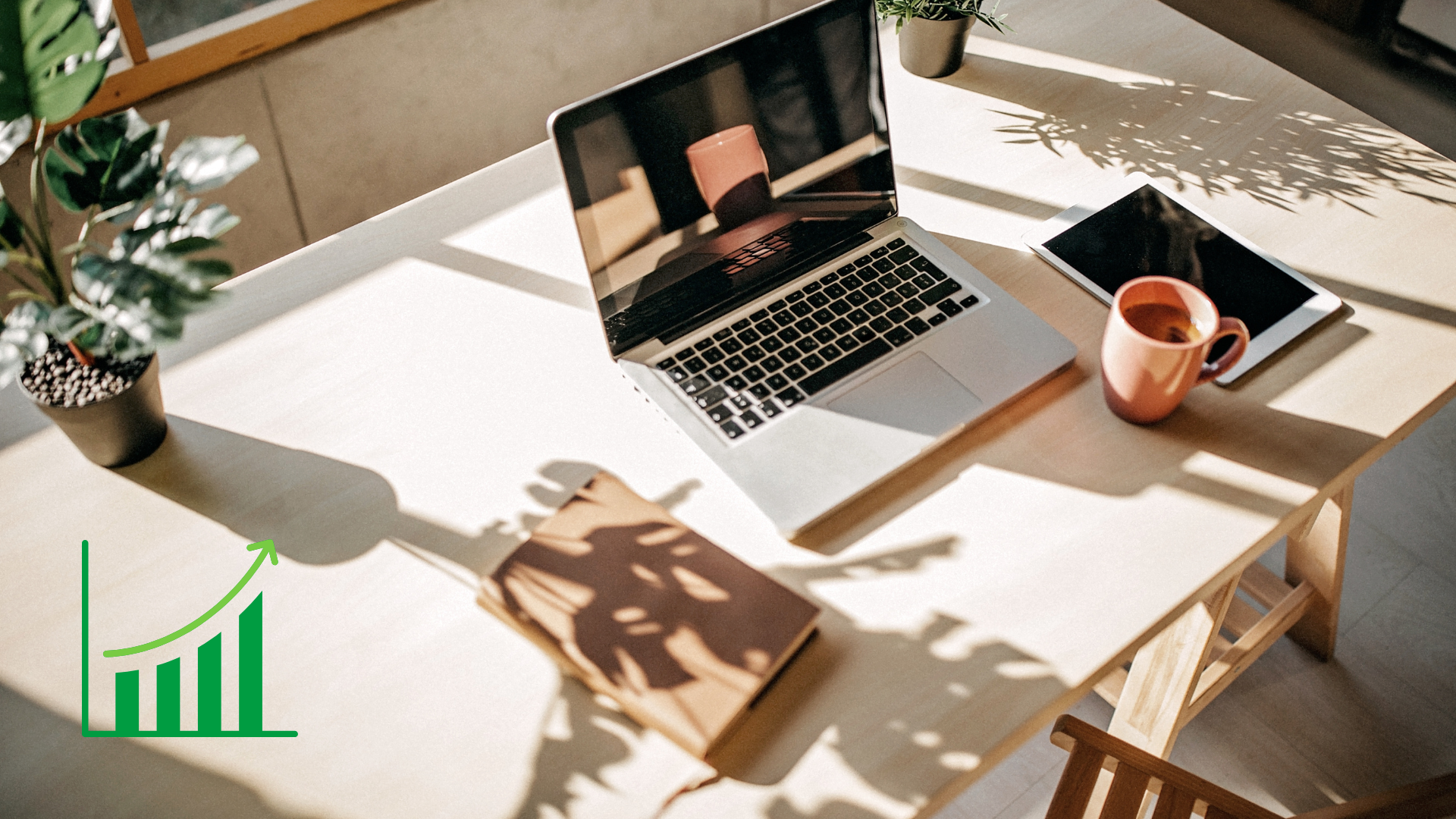Sunlit desk with a laptop, tablet, notebook, and coffee mug, symbolising productivity and upcoming Microsoft 365 changes.