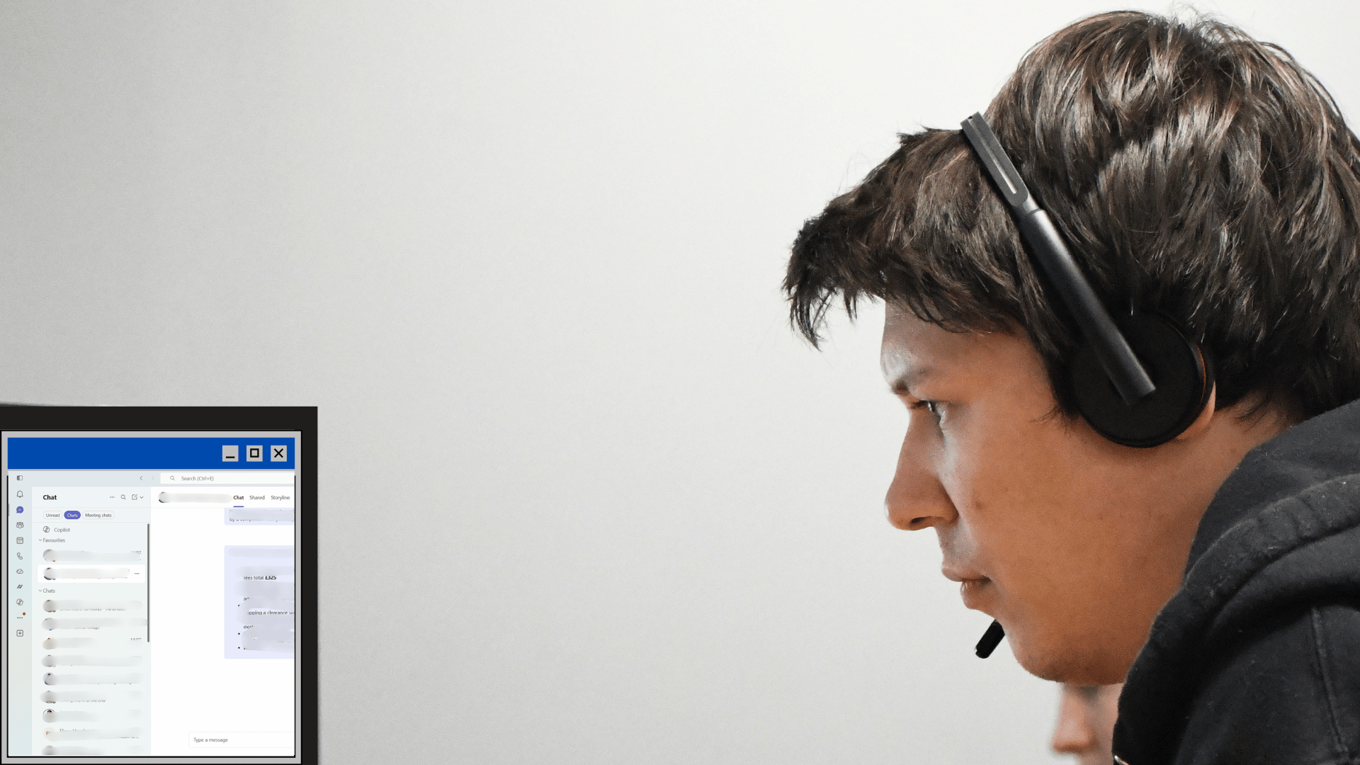 Netitude engineer wearing a headset on a business call using Microsoft Teams Telephony at his desk