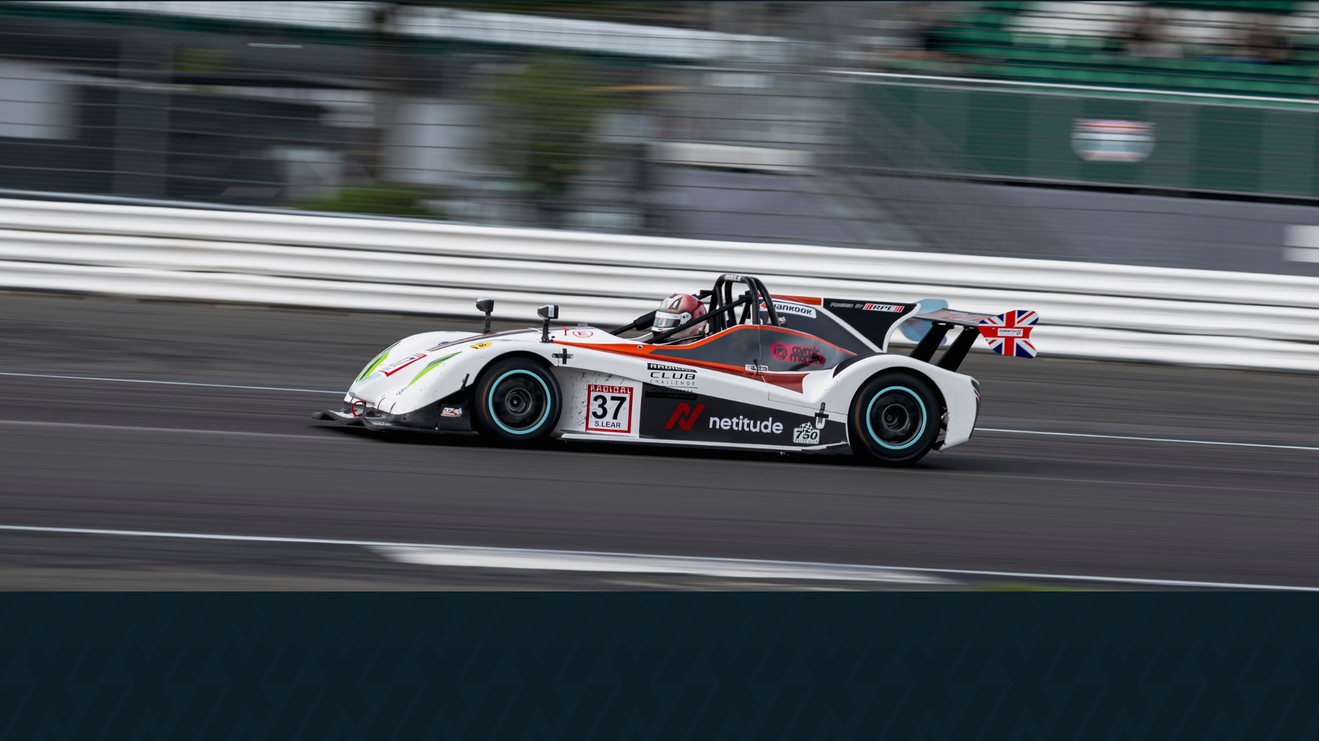 Scott Lear's Radical SR3 car #37 racing at Silverstone National, with the Netitude logo prominently displayed on the bodywork.