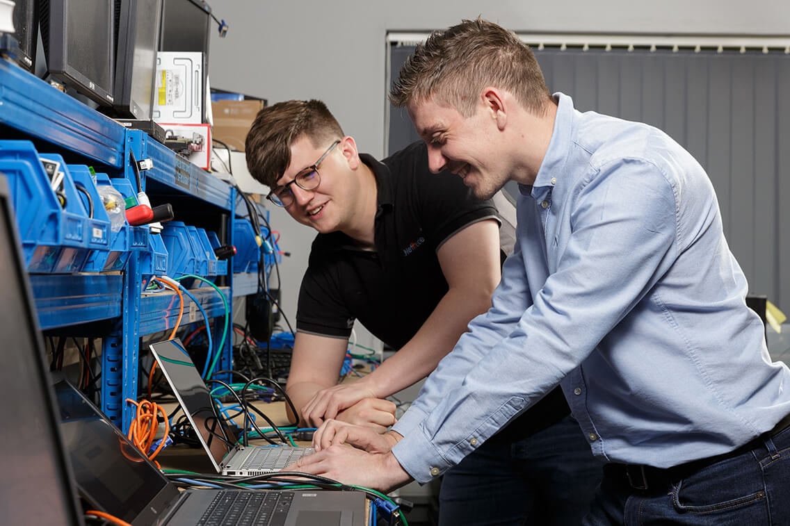 Project Engineers setting up a laptop for a client