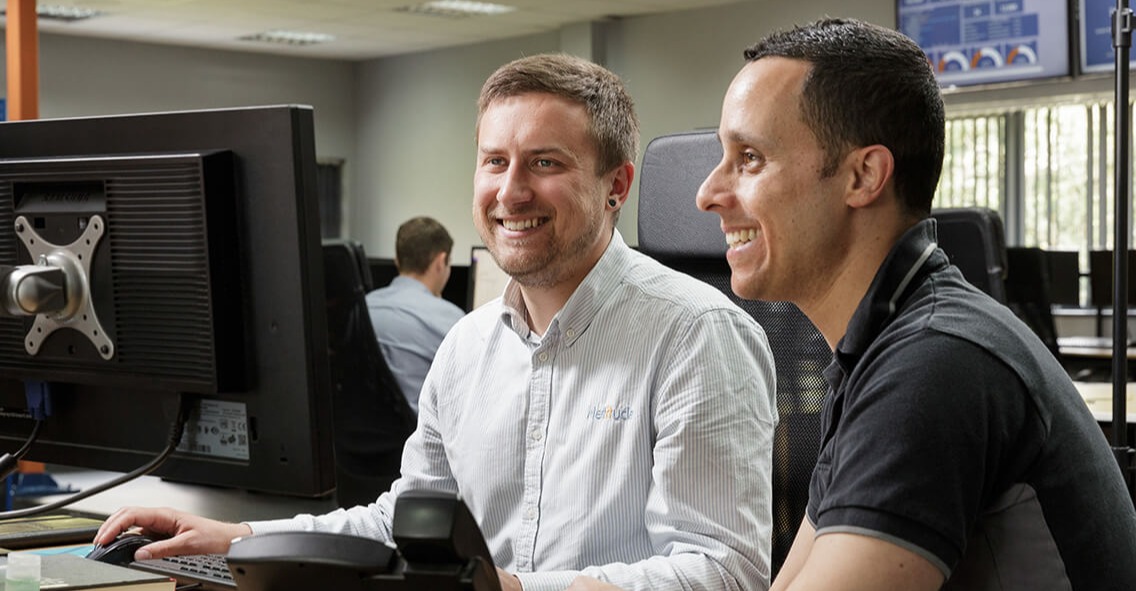 Two male engineers working together on a Co-managed IT project