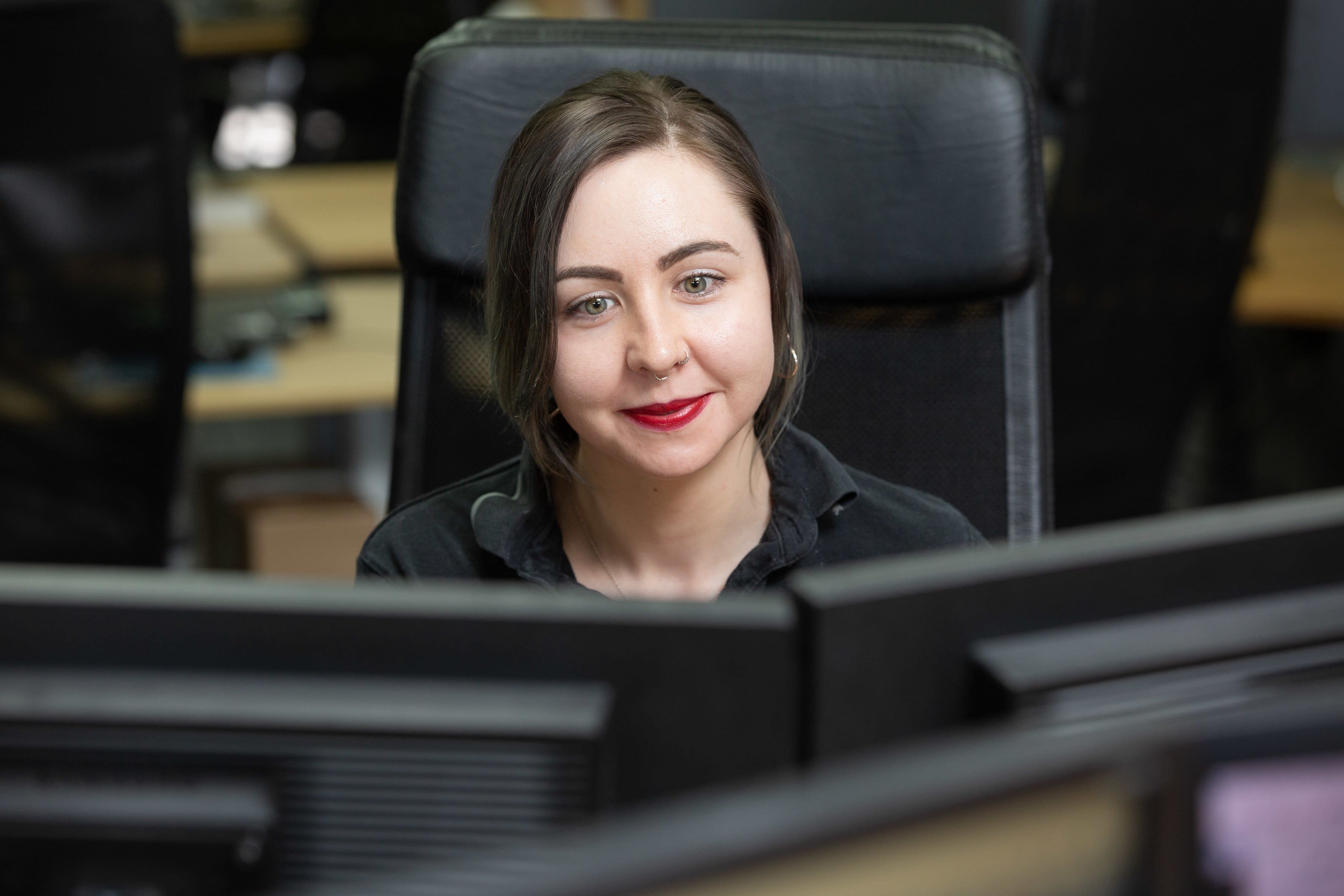 Customer Service Manager, working at her computer