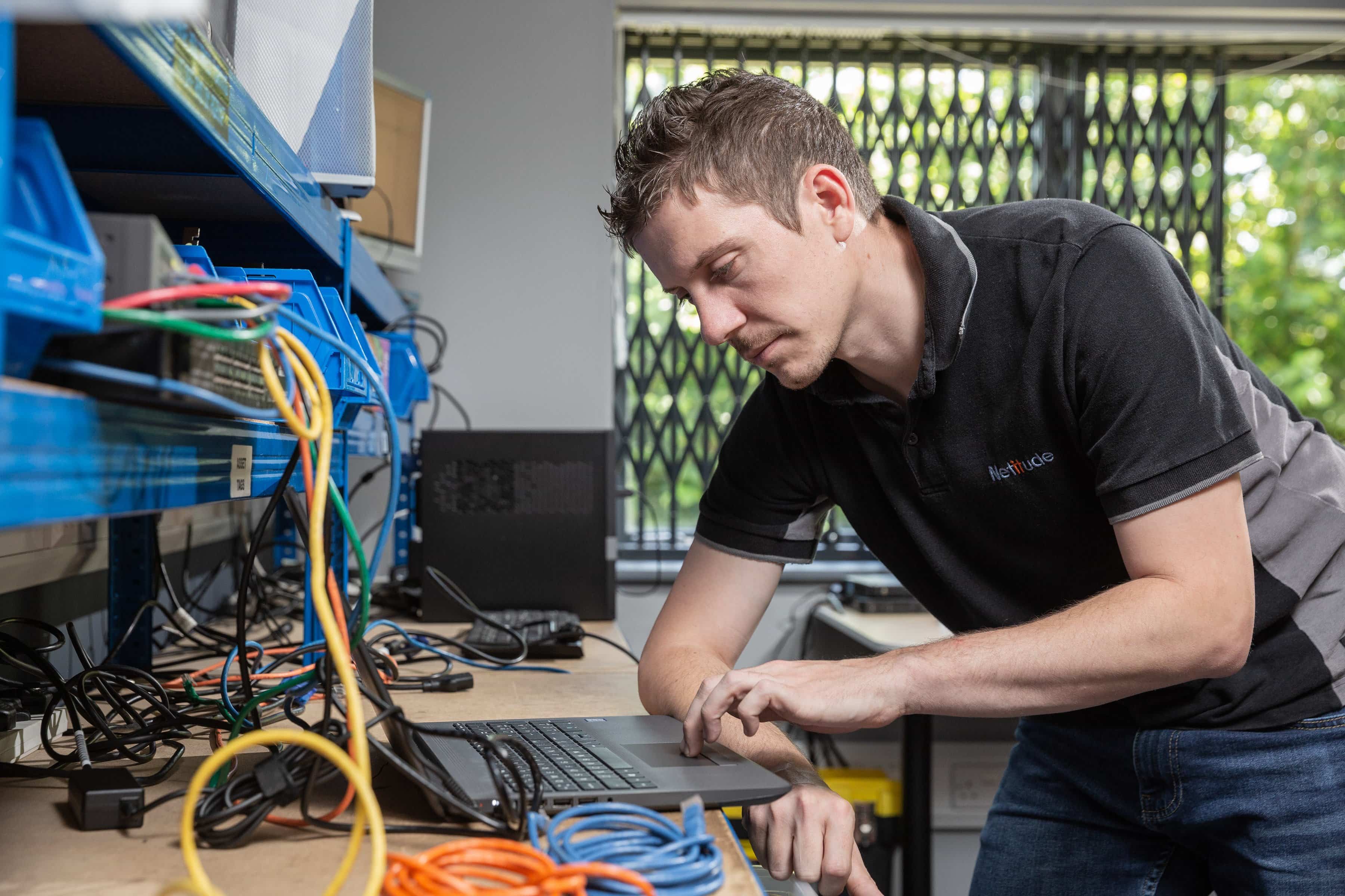 Engineer setting up a laptop on a build desk